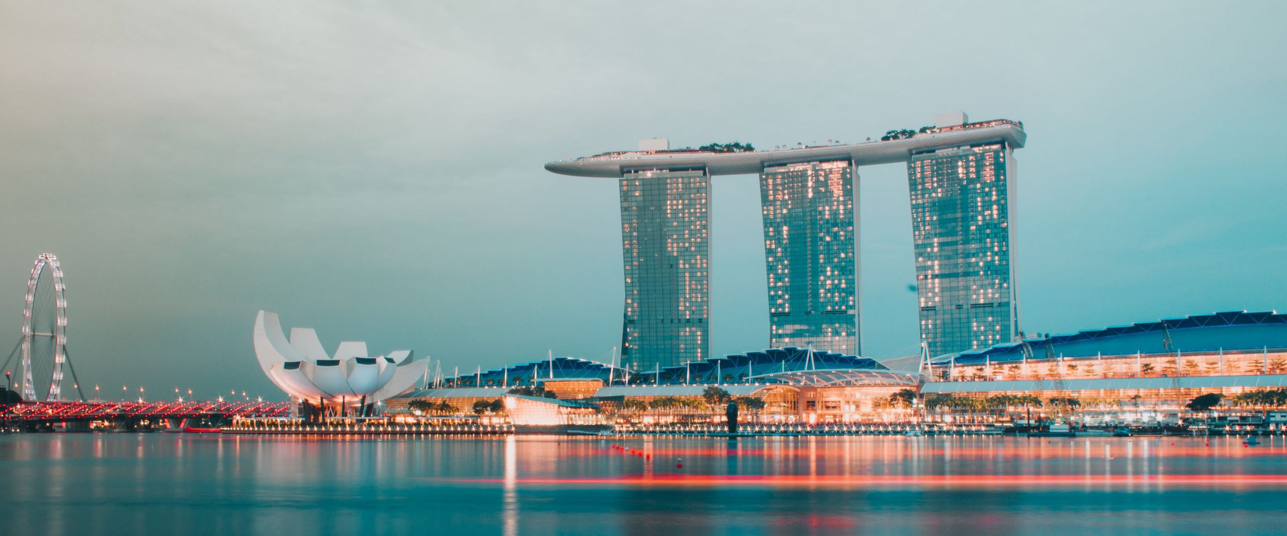 View of the Marina Bay and Marina Bay Sands Hotel lit up at dusk Singapore